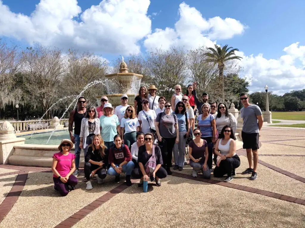 Group of people posing in front of a fountain.